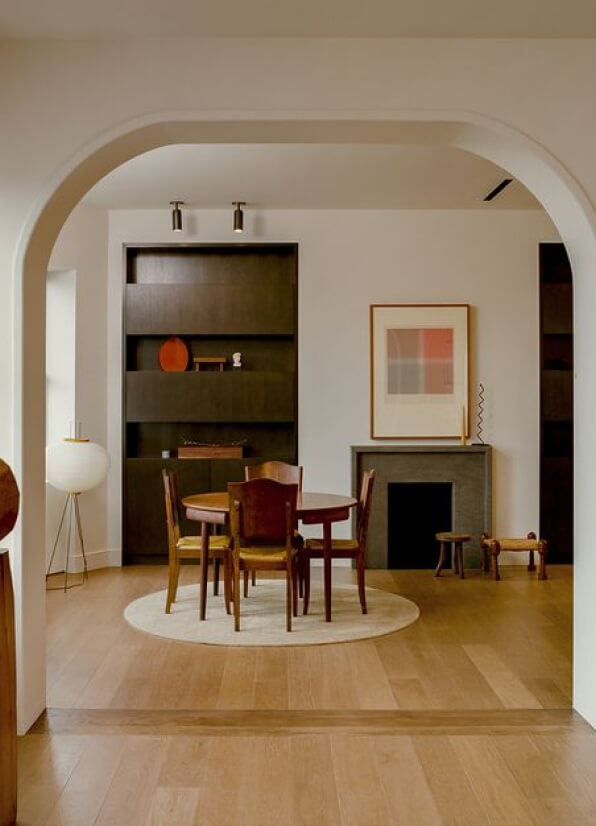 A dining room with a table and chairs.