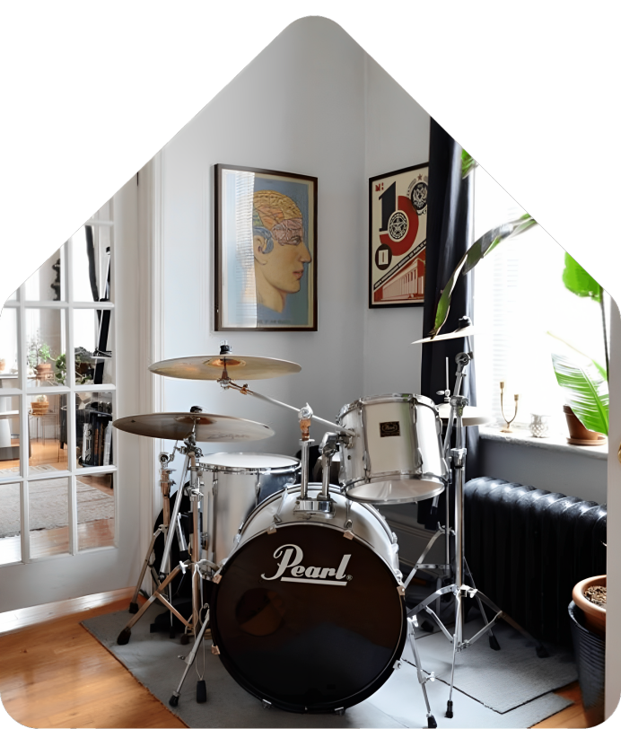 A room with a drum set and pictures on the wall.